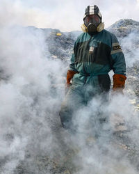 Rear view of man spraying water