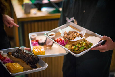 Midsection of woman holding food on table