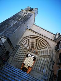 Low angle view of historic building against clear blue sky