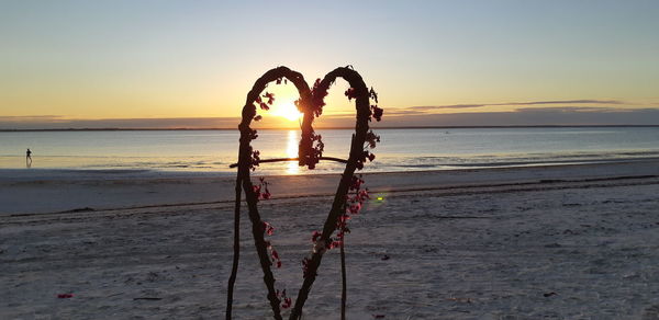 Heart shape at beach during sunset