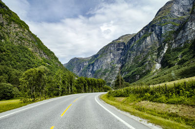 Road amidst mountains against sky