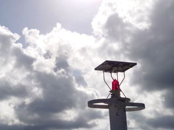 Low angle view of communications tower against sky