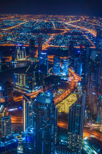 High angle view of illuminated city buildings at night