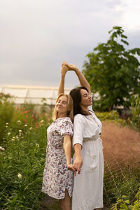 A young mother with a teenage daughter spends time in the garden. family holiday and togetherness.