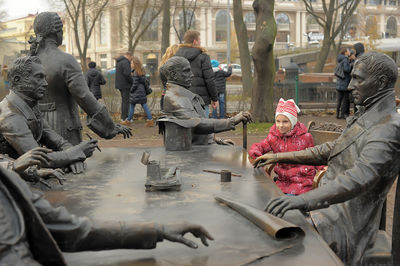 People sitting on street in city