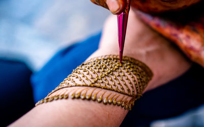 Cropped hand of woman holding equipment