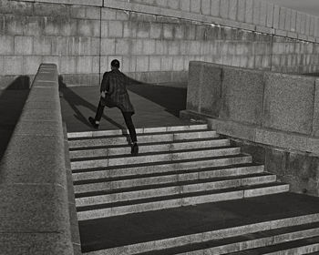 Low section of woman walking on steps