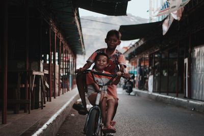 Portrait of man riding bicycle on city