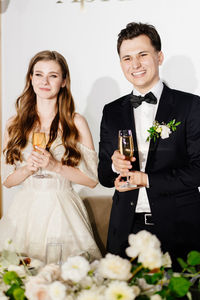 Portrait of bridegroom standing outdoors