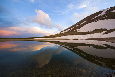 Alpine mountain lake landscape and view, snow and clouds in javakheti, georgia