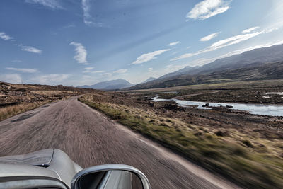 Road amidst landscape against sky