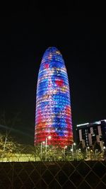 Illuminated cityscape against sky at night