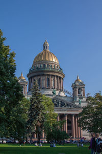 Church by building against clear blue sky