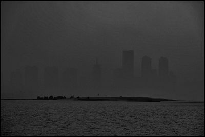 Scenic view of sea and buildings against sky