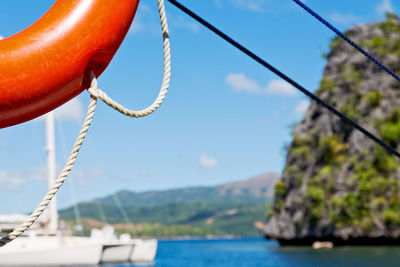 Close-up of rope against sea against sky