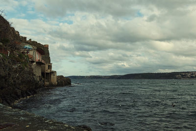 Scenic view of sea against cloudy sky