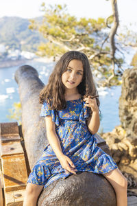 Young woman sitting outdoors