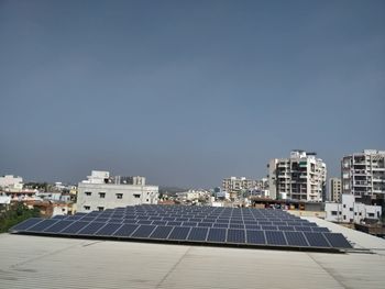 Scenic view of solar panels on buildings against clear sky