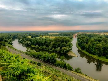 Scenic view of river amidst trees against sky