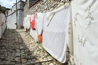 Clothes drying on footpath against building