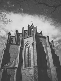 Low angle view of built structure against cloudy sky