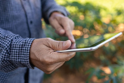 Close-up of man using mobile phone