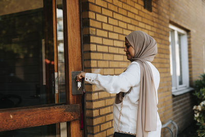 Woman entering building