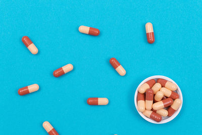 High angle view of multi colored pencils on blue background