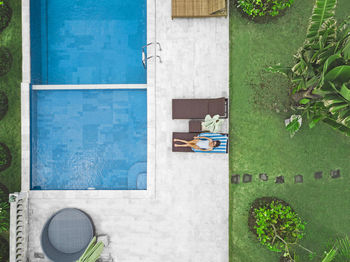 Aerial view of attractive woman near the pool at resort