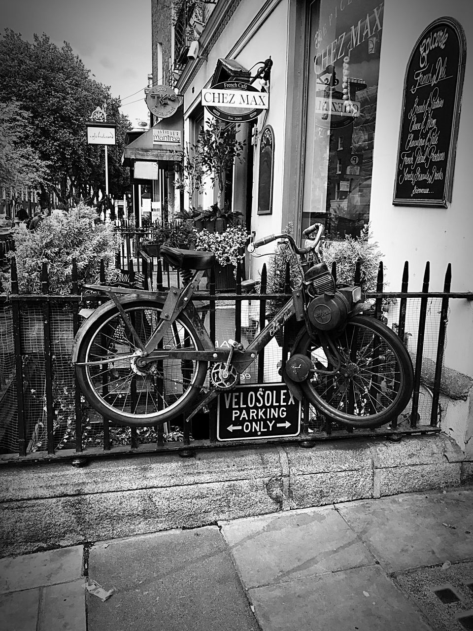 BICYCLE PARKED AGAINST BUILDING