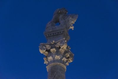 Low angle view of statue against clear blue sky