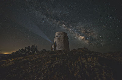 Low angle view of old building against sky at night