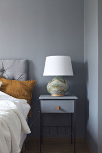 Lamp on night stand in bedroom