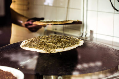 Midsection of man preparing food in kitchen