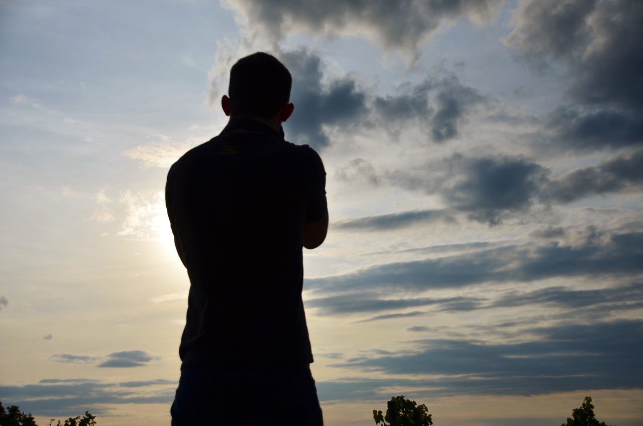 cloud - sky, sky, silhouette, sunset, standing, one person, outdoors, men, lifestyles, rear view, nature, beauty in nature, people, day, adult