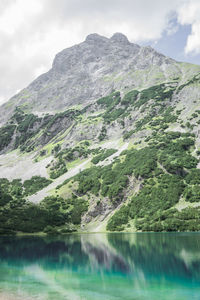 Scenic view of calm lake against mountain range