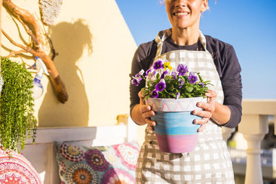 Portrait of a smiling young woman holding flower