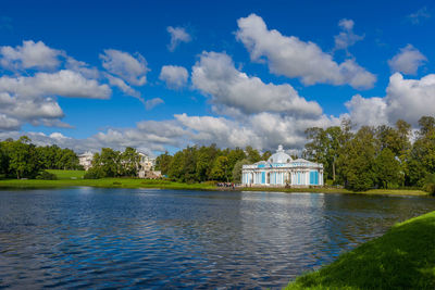 Scenic view of lake by building against sky