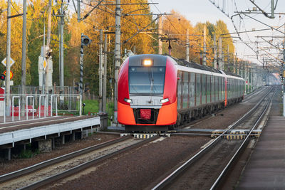 Modern intercity high speed train at sunset. commercial suburban railroad transportation concept.