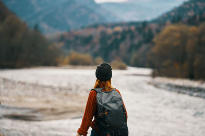 Rear view of man looking at mountains