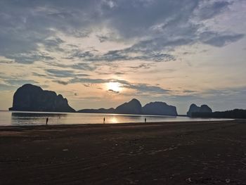 Scenic view of beach against sky during sunset