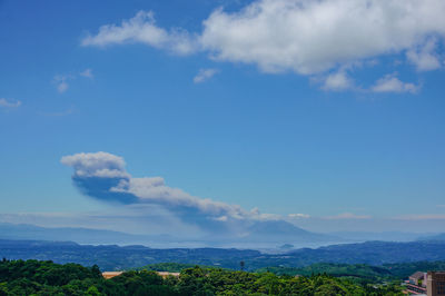 Scenic view of mountains against blue sky