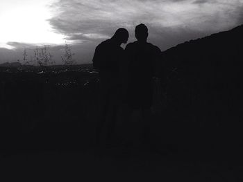 Silhouette couple standing against sky