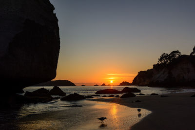 Scenic view of beach against sky during sunset