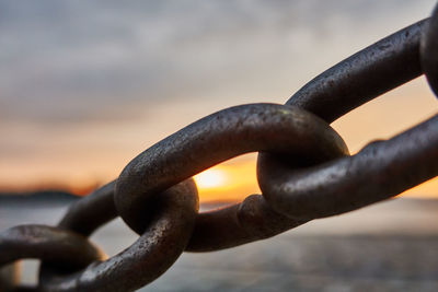 Close-up of rusty metal chain on rock