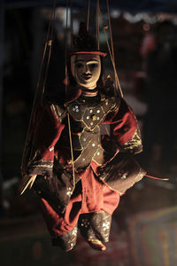 Close-up of person holding decoration hanging on metal