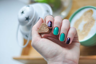 Cropped image of woman holding cookie