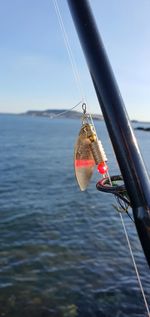 Close-up of sailboat on sea against sky