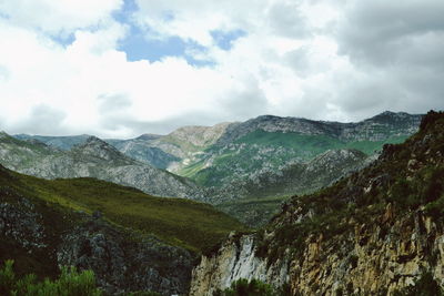 Scenic view of mountains against cloudy sky