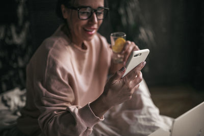 Midsection of woman using mobile phone